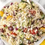 Green Lemon Orzo Salad in a large bowl with a spoon.