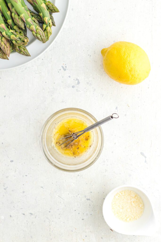 Lemon and garlic powder in a small bowl with a whisk.