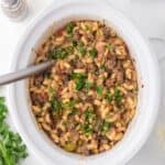 Slow cooker hamburger helper topped with chopped parsley.