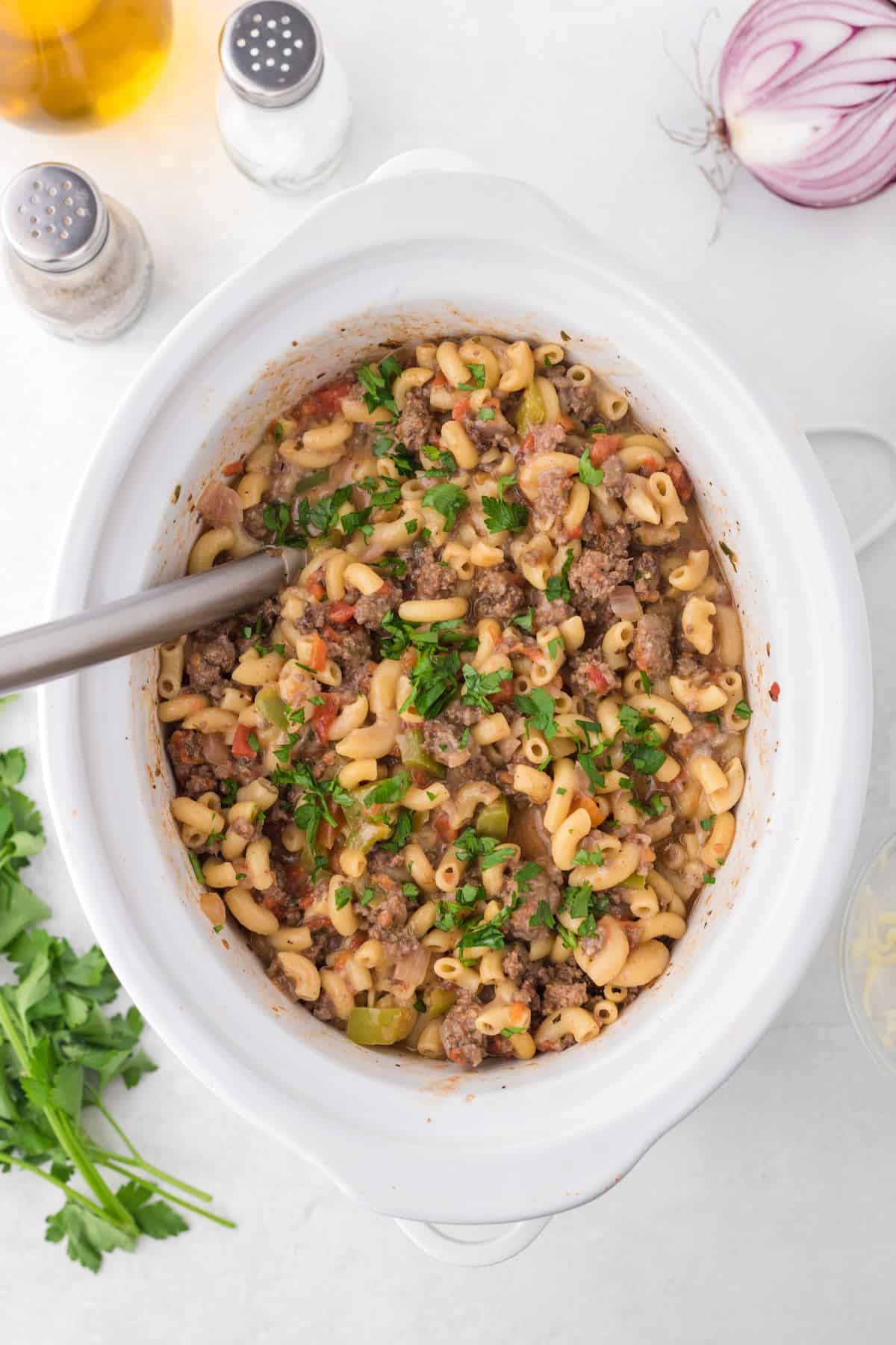 Slow cooker hamburger helper topped with chopped parsley.