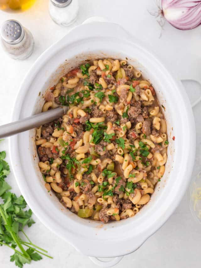 Slow cooker hamburger helper topped with chopped parsley.