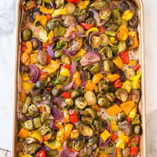 A sheet pan full of chopped and roasted veggies.