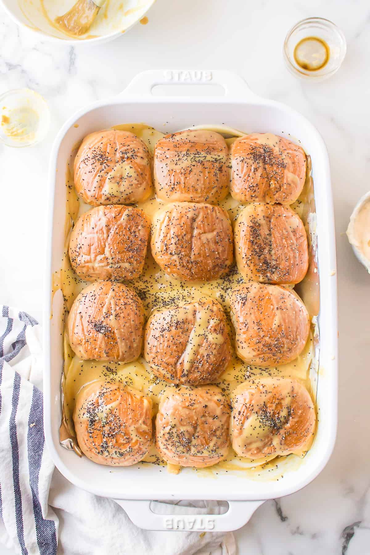 Melted butter, Dijon mustard, and Worcestershire sauce over slider tops, sprinkled with poppy seeds.