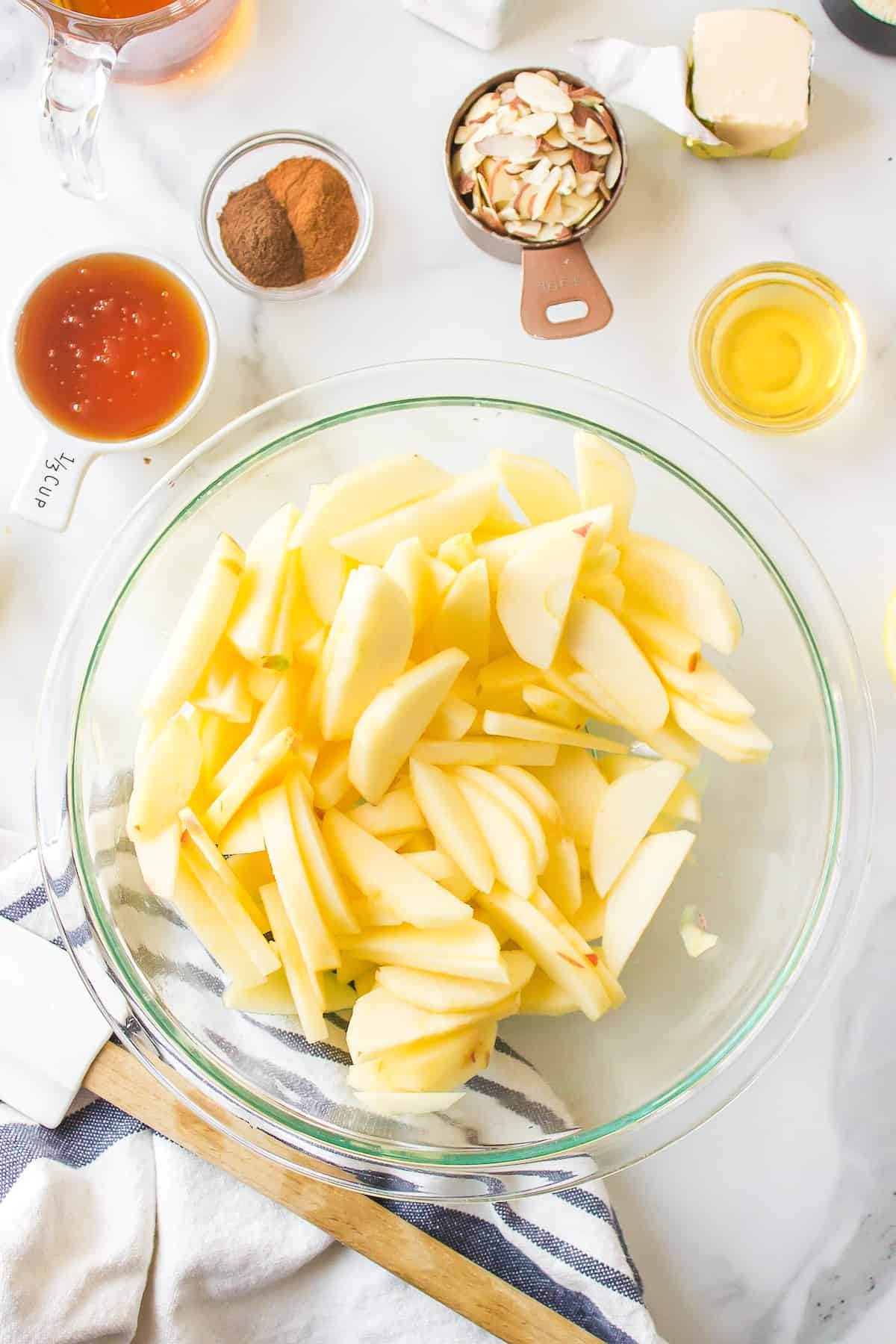 A bowl of peeled and sliced apples.