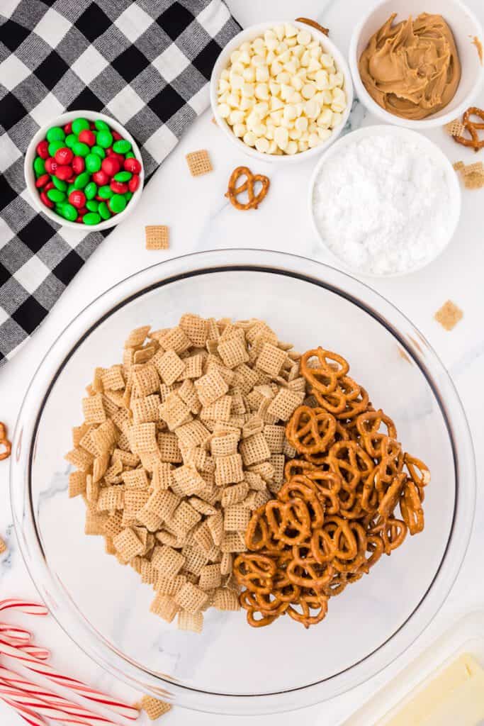 Chex cereal and pretzel twists in a bowl.