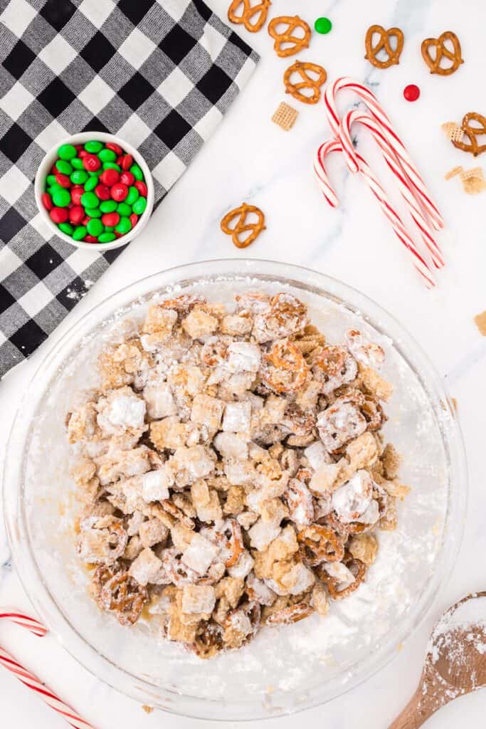 Powder sugar covered chex mix in a bowl.