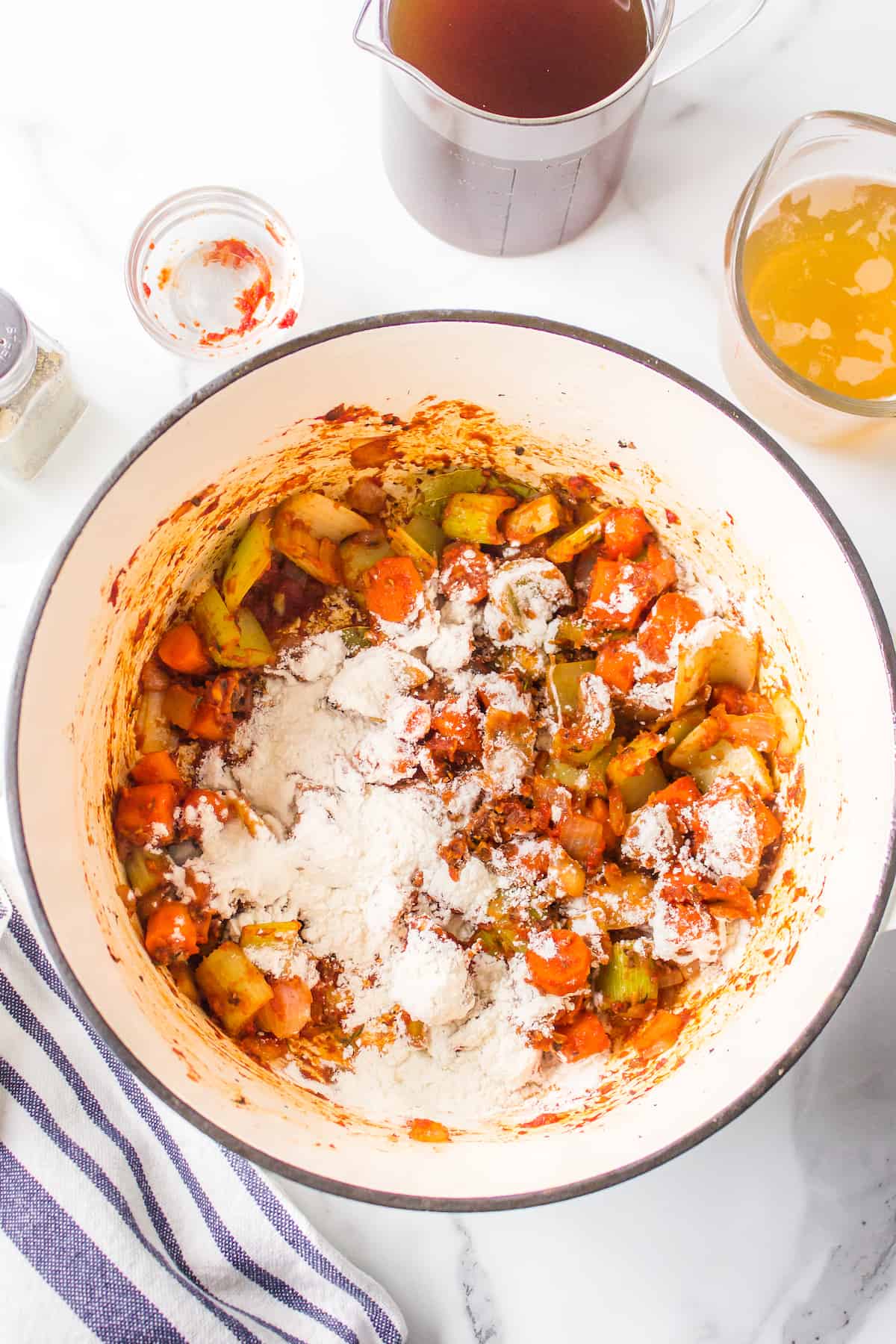 Cooked vegetables with flour in a Dutch oven.