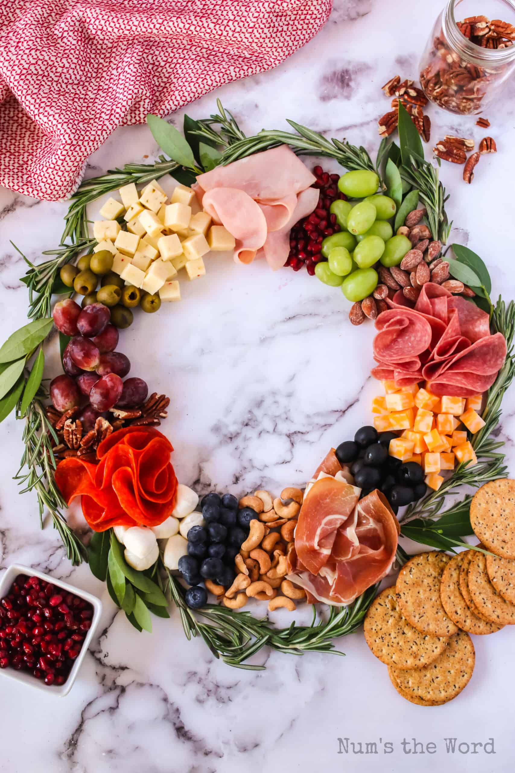 Fruit, nuts, meat and cheese in a wreath shape.