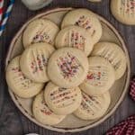 A plate of shortbread cookies with sprinkles.