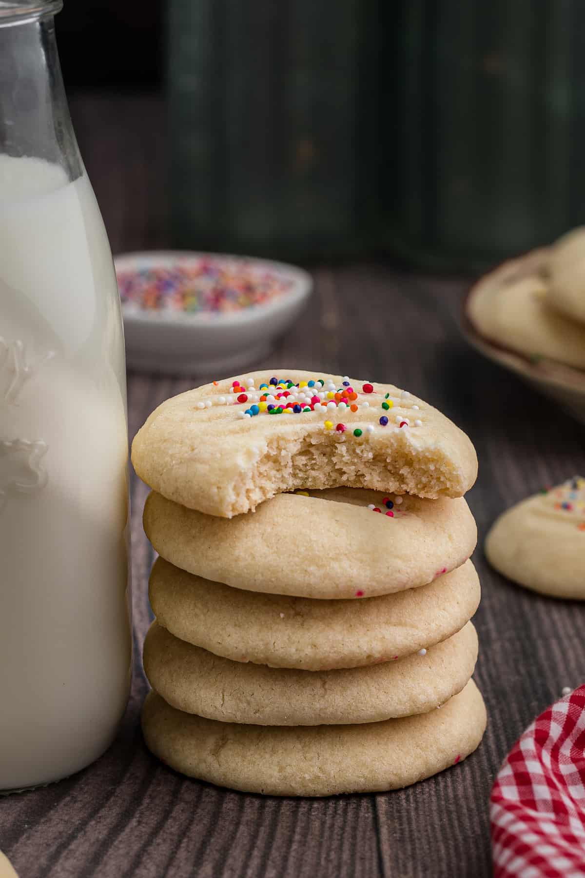 A stack of shortbread cookies and a bottle of milk.