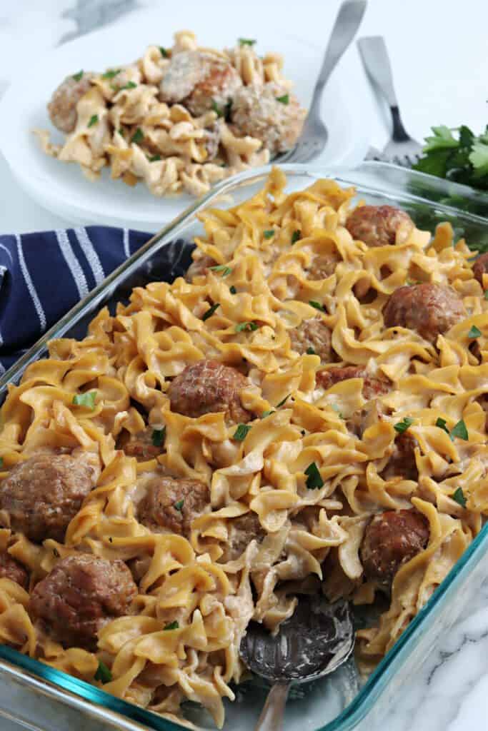 Swedish Meatball Casserole on a plate with a scooped out portion alongside.