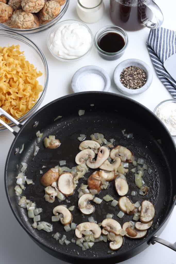 Mushrooms and onions in a skillet, sauteed in butter.