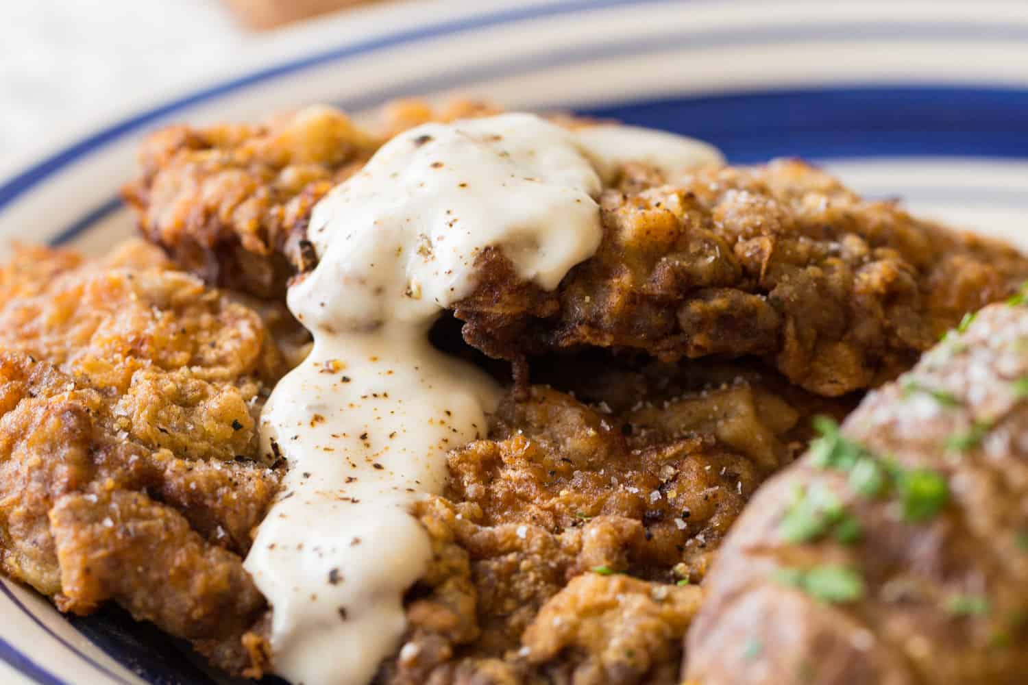 Chicken fried steak topped with white gravy.