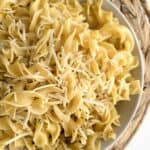 Buttered noodles topped with shredded parmesan cheese.