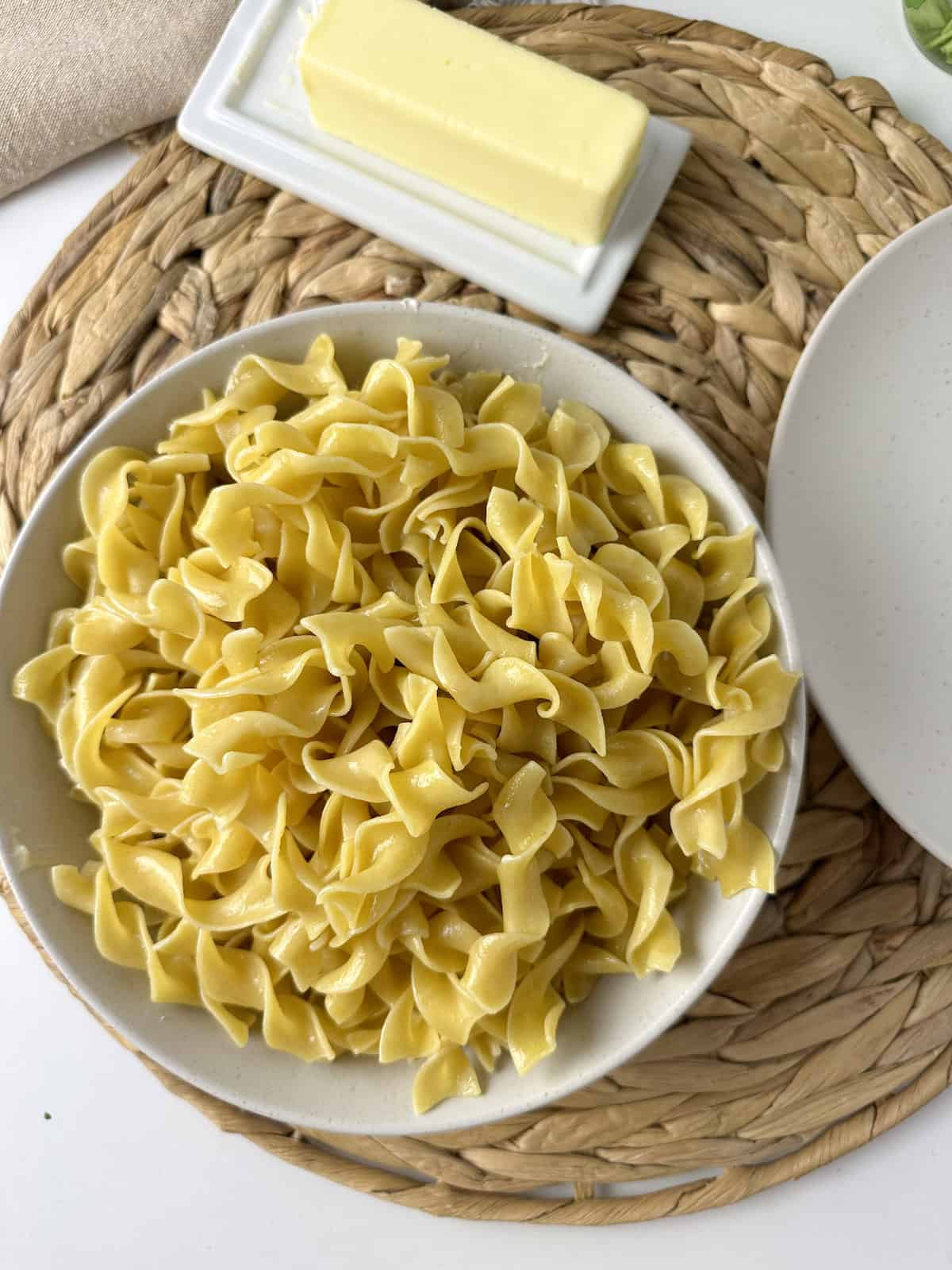 A plate full of buttered egg noodles.