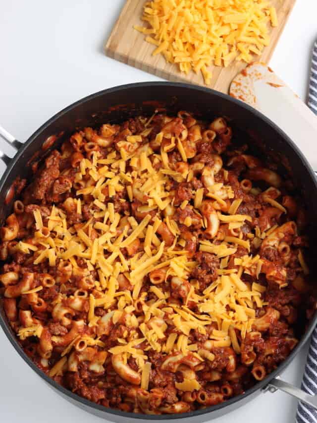Homemade beefaroni with cheese in skillet.