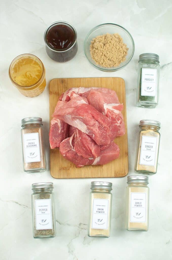 Ingredients to make instant pot country style ribs including pork, brown sugar, chicken stock, bbq sauce, and spices.