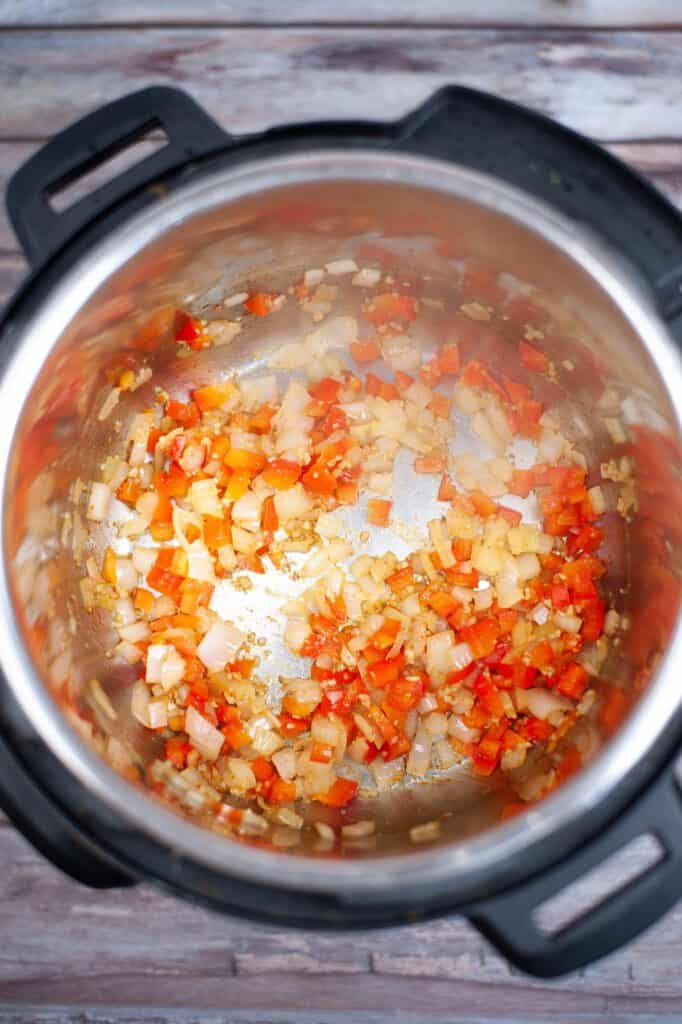 Butter, onion and bell peppers cooking in the Instant Pot.