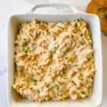 A square casserole dish filled with tuna noodle casserole.