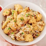 A bowl of air fryer cauliflower topped with parmesan cheese.