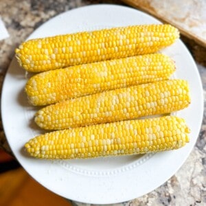 A plate of air fried corn on the cob.