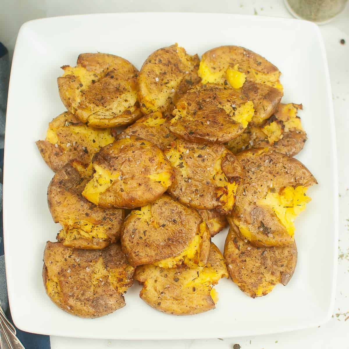 Seasoned air fryer baby potatoes on a plate.