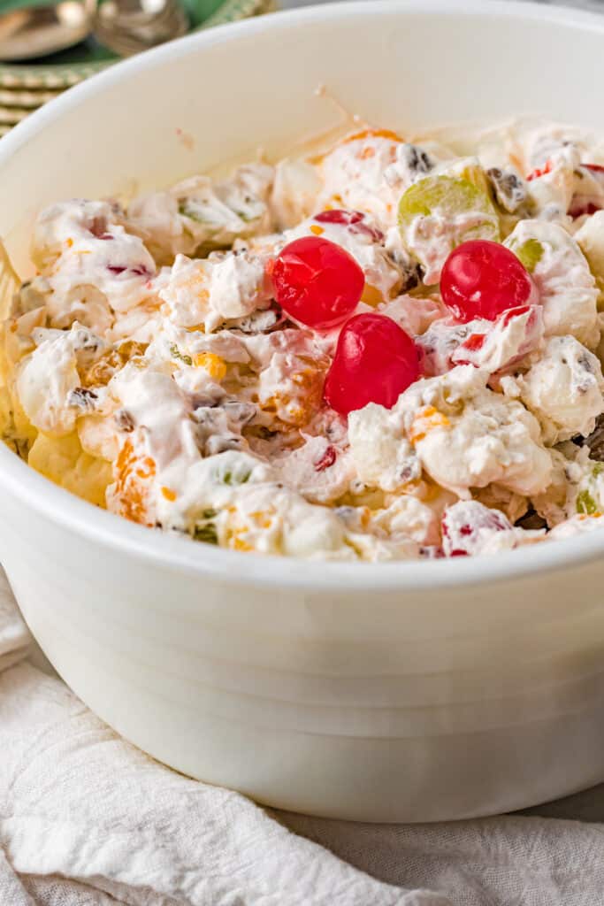A bowl of ambrosia fruit salad with cool whip.