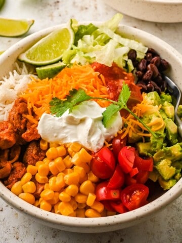 A chipotle chicken bowl with all the toppings loaded.