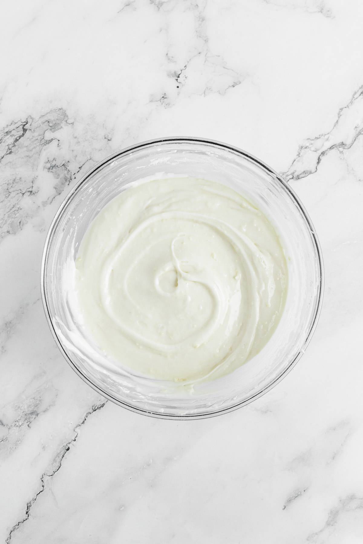 Cream cheese frosting in a mixing bowl.