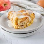 A slice of cinnamon roll baked and topped with icing.