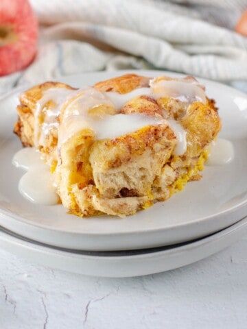 A slice of cinnamon roll baked and topped with icing.