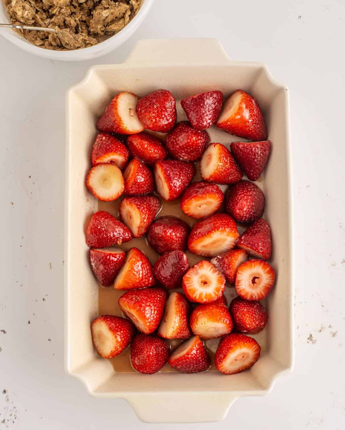 Whole strawberries spread in a baking dish.