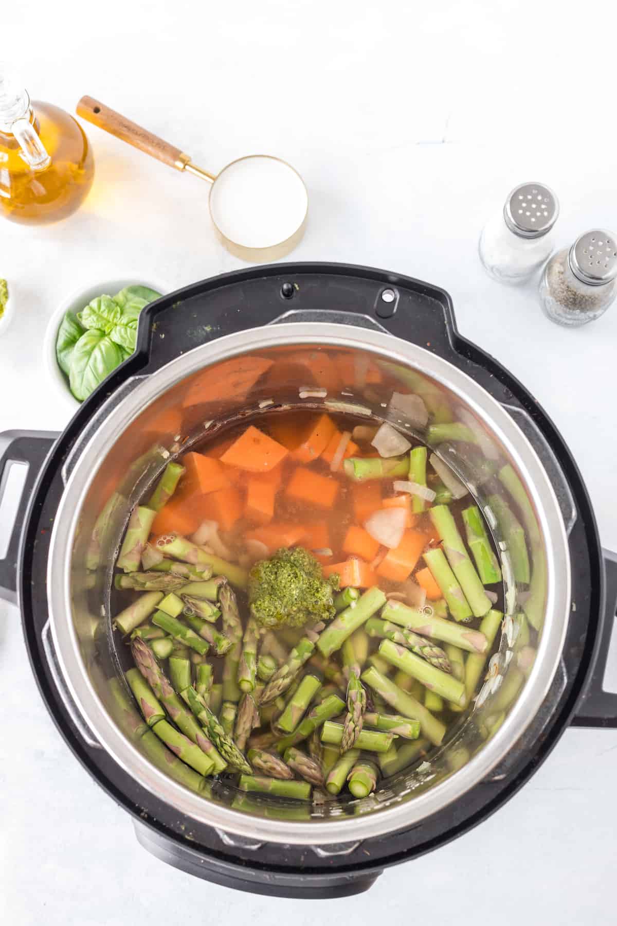 Sweet potatoes, chopped asparagus and spices in a pressure cooker.