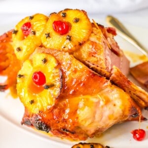 A ham with a pineapple honey glaze, topped with cherries and cloves.