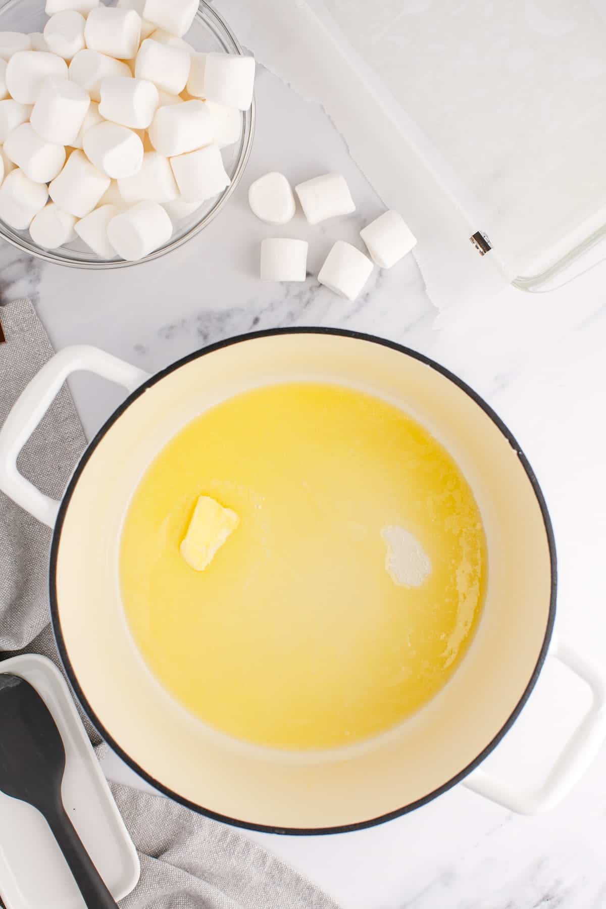 Butter melting in saucepan to make cereal bars.