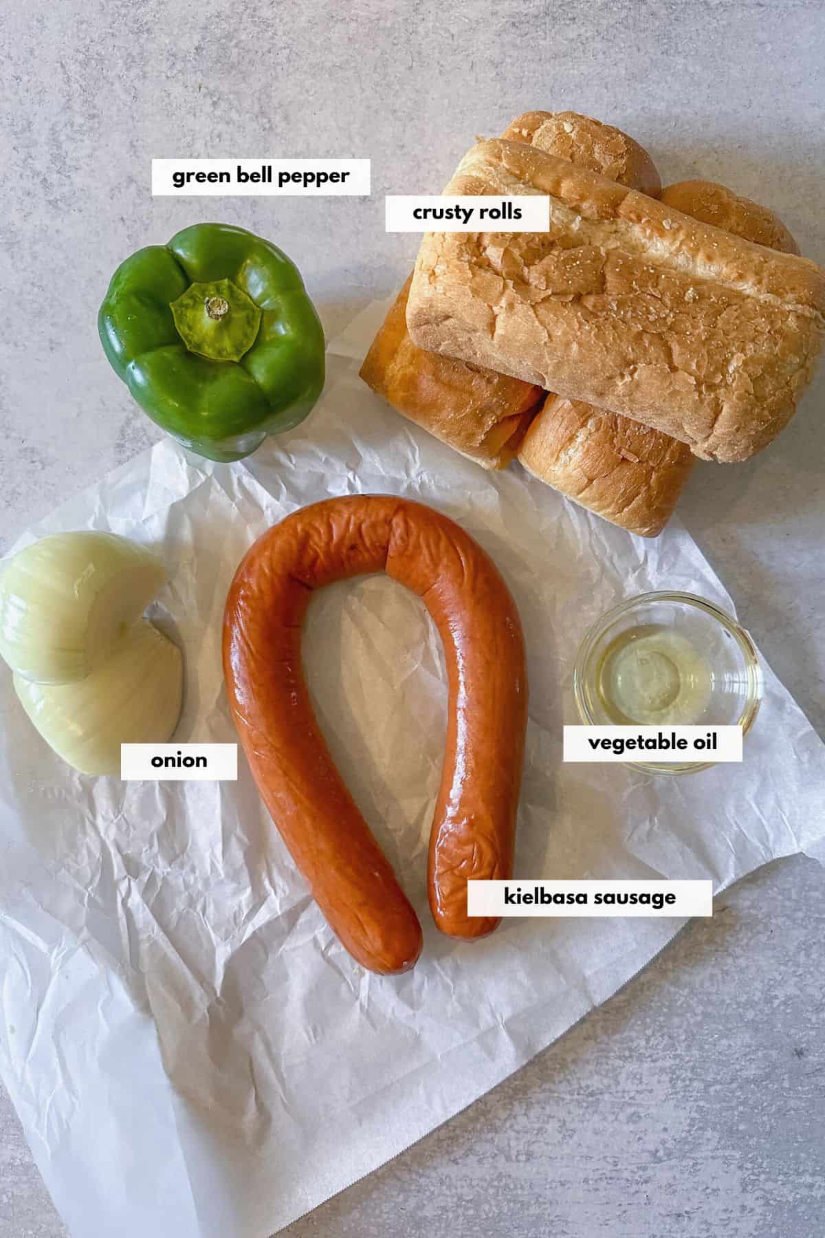 Ingredients are kielbasa sausage, onion, green pepper, olive oil and crusty Italian rolls.