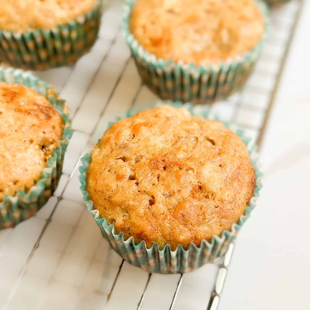 Sourdough banana muffins on a wire cooling rack.