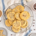 A platter of cream cheese chocolate chip cookies with sprinkled chocolate chips.