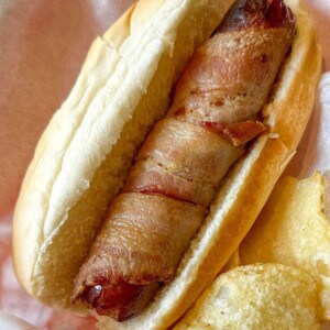 Bacon wrapped air fryer hot dog on a bun.
