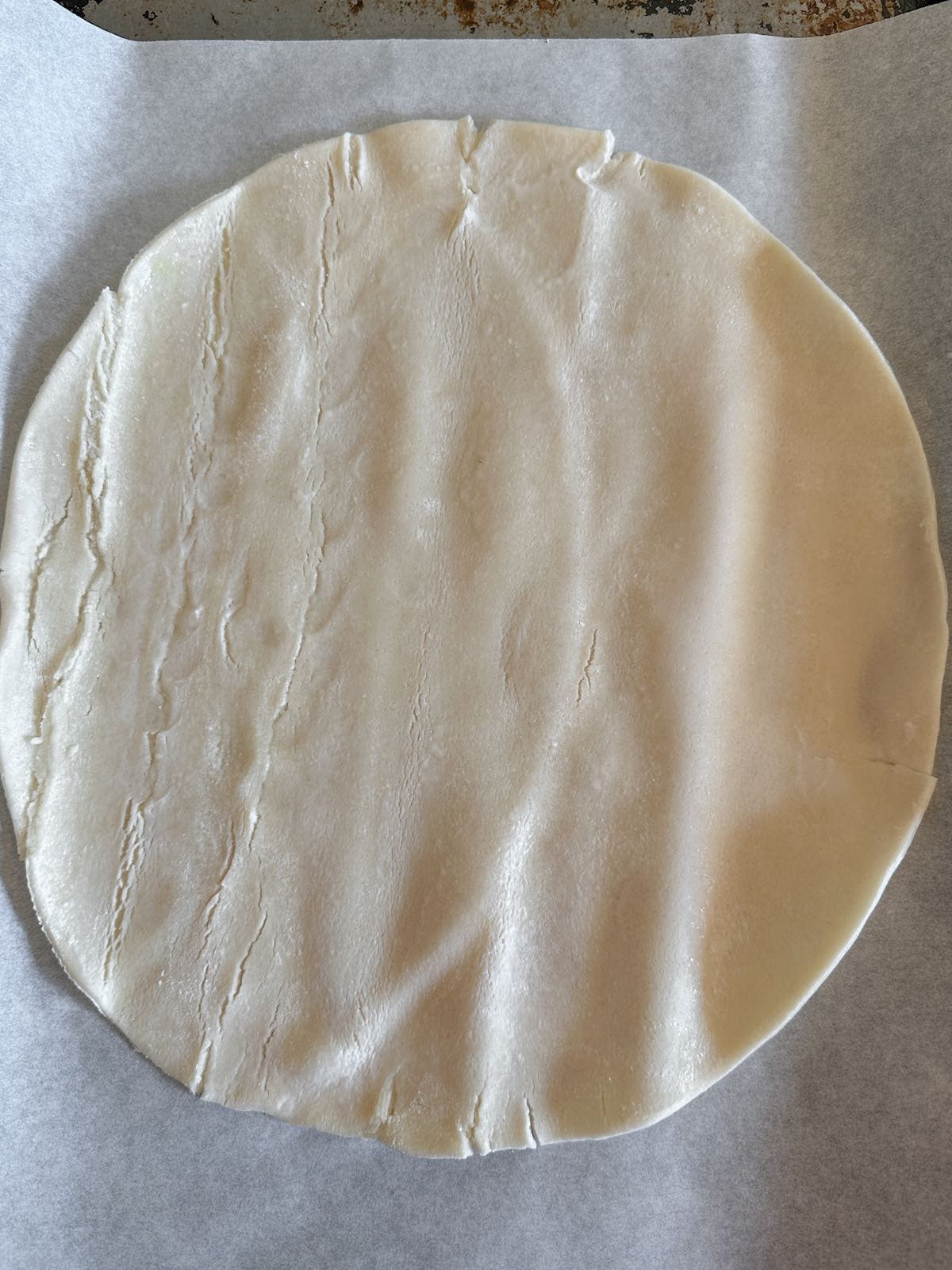 Store bought pie crust on a parchment paper covered sheet pan.