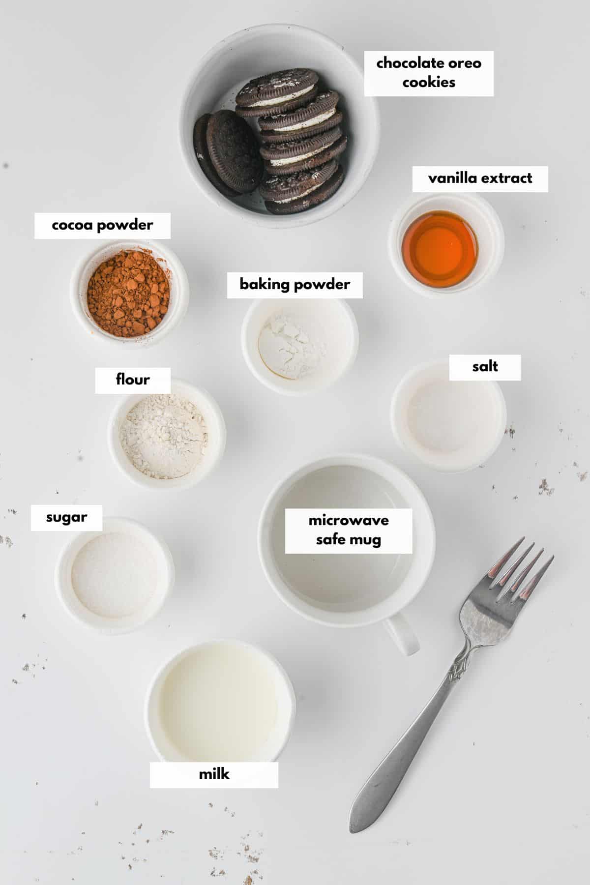 Ingredients to make an oreo mug cake include chocolate cream cookies, cocoa powder, baking powder, salt, sugar, milk and vanilla.