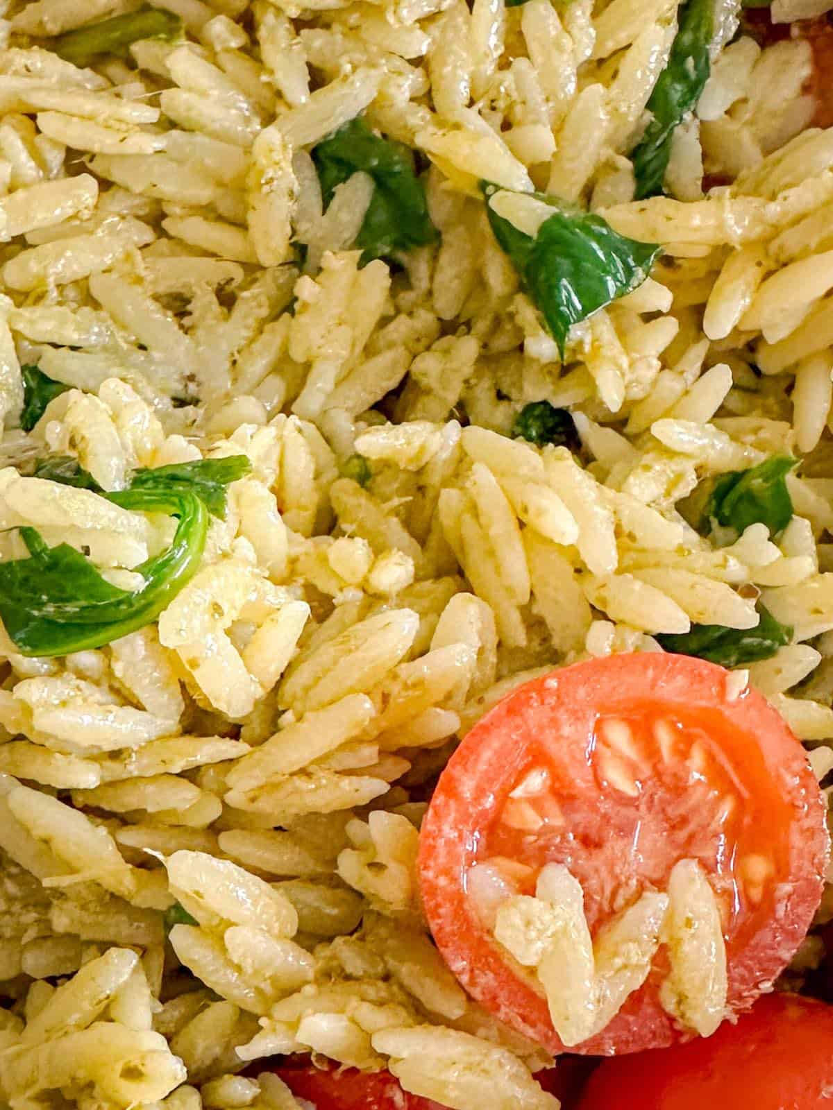 Pesto sauce added to the cooked orzo, spinach and tomatoes.