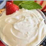 Marshmallow fluff fruit dip with a strawberry on top.