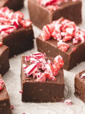 Cubes of chocolate fudge topped with crushed candy canes.