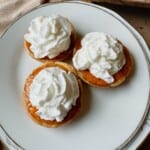 Three muffin tin pumpkin pies on a plate.