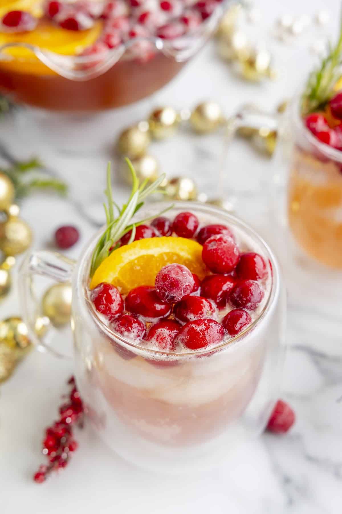 A glass of Christmas punch on a countertop.