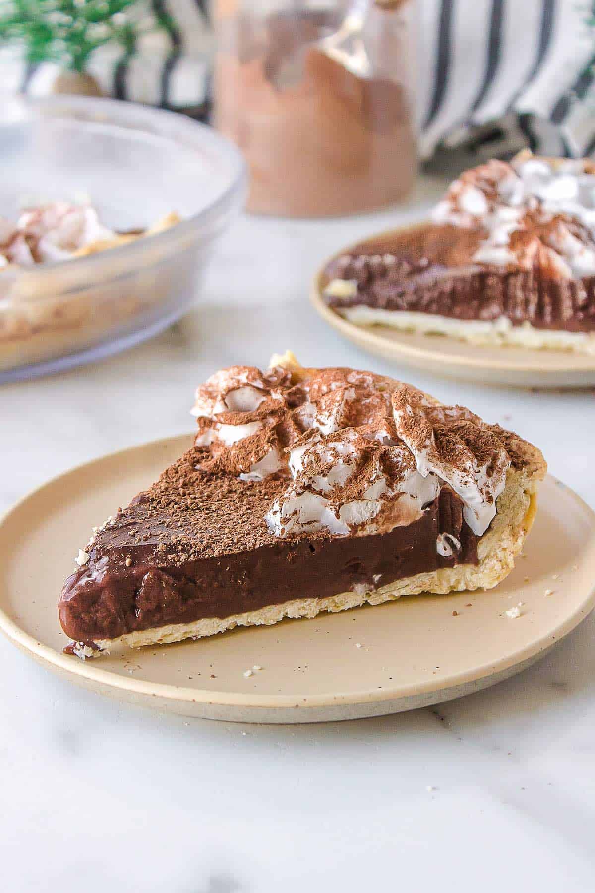 A creamy chocolate pie slice on a plate.
