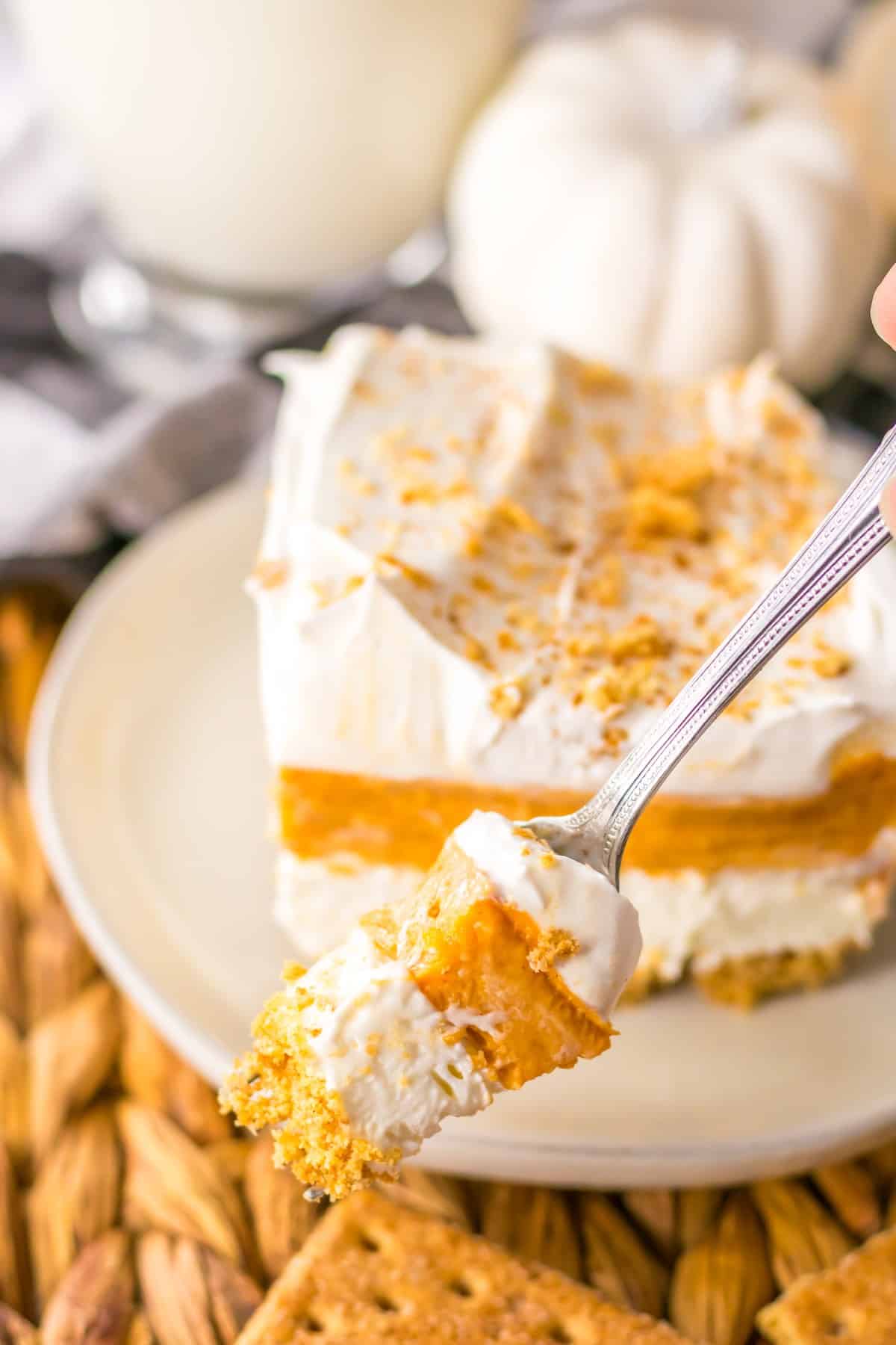 A forkful of layered pumpkin dessert.