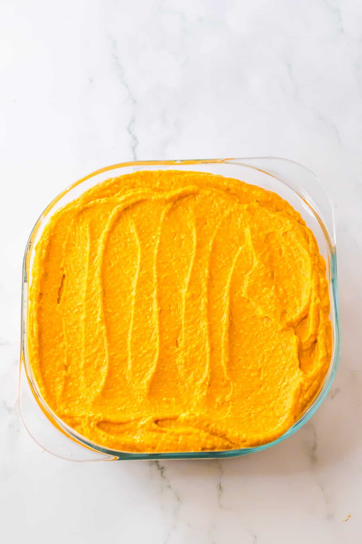 Pumpkin layer spread in a square dish.