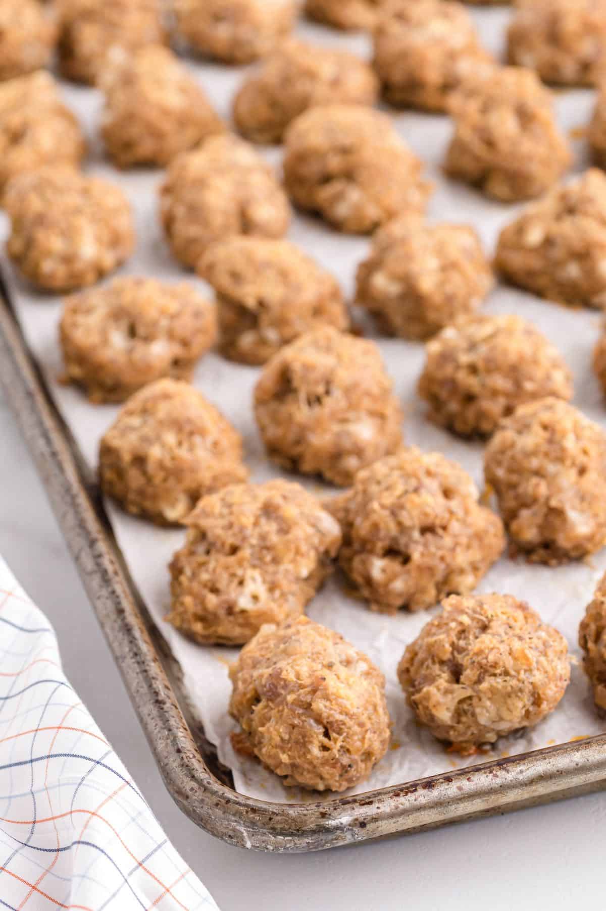 Sausage balls without bisquik baked on a cookie sheet in rows.